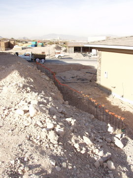 Neighbors building a retaining wall so we can build property line wall