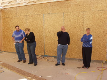 Tom, Steph, JD and Kath survey garage